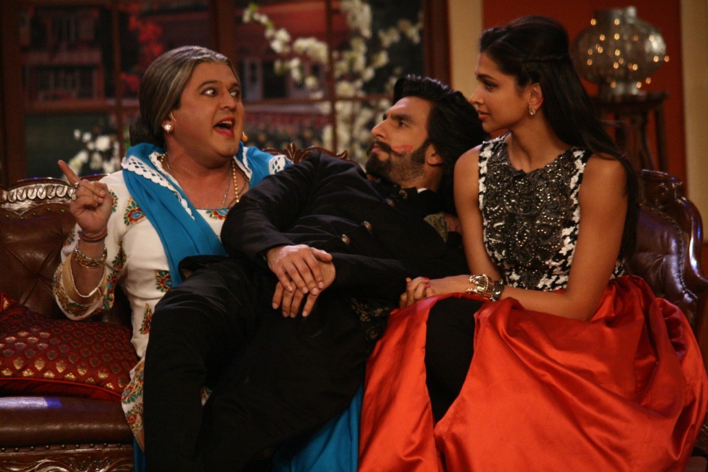 Ranvir Sing gets pulled on to Dadi's lap, while Deepika looks on the sets of Comedy Nights with Kapil